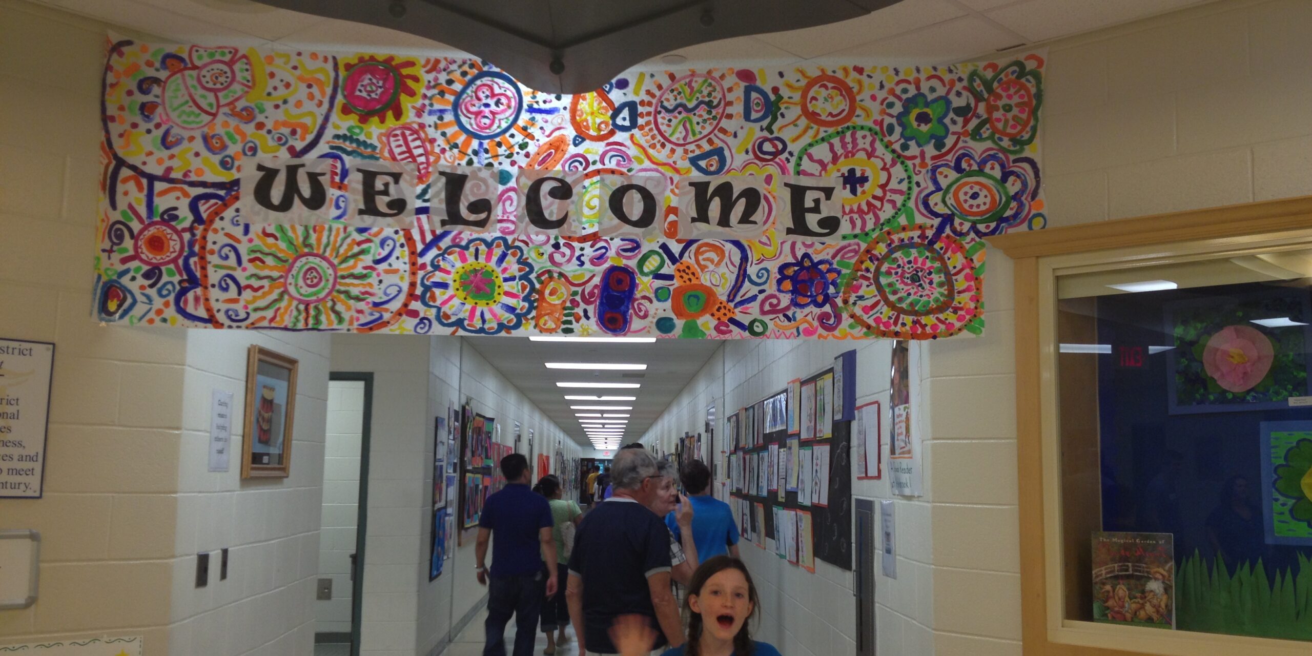 Colorful welcome banner with vibrant patterns and "Welcome" text.