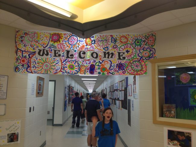 Colorful welcome banner with vibrant patterns and "Welcome" text.
