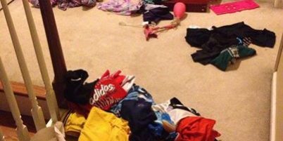 Clothes scattered on staircase and floor in a home setting.